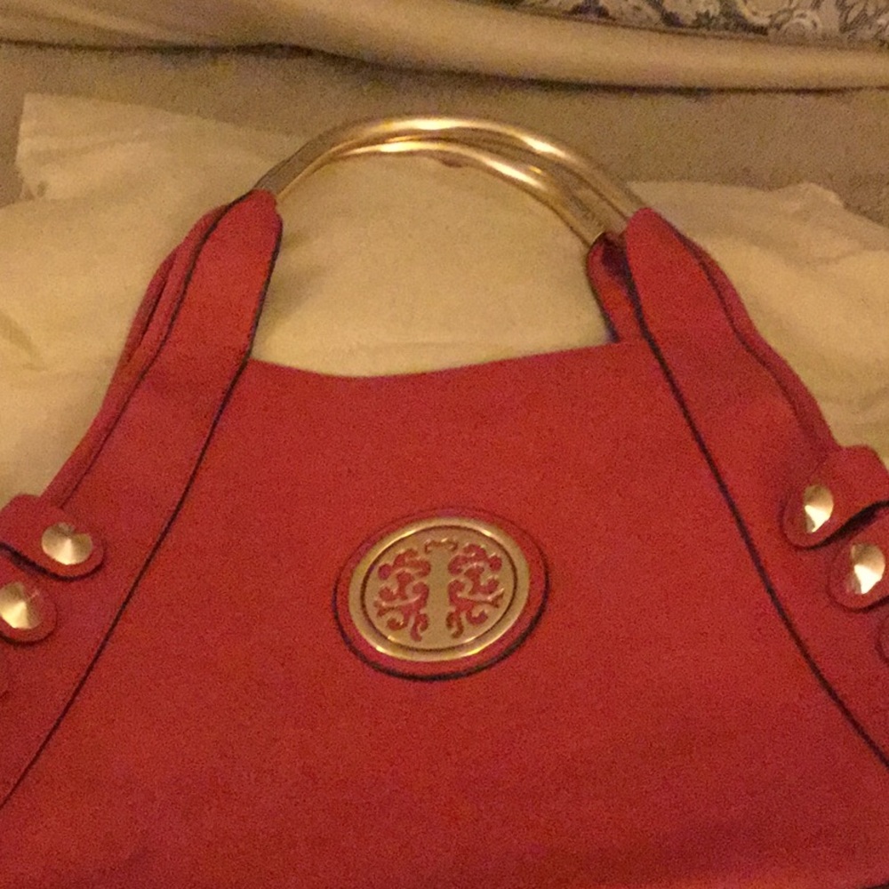 Red handbag with gold metal handles